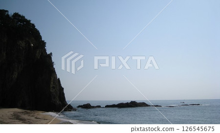 Clear blue sky, blue sea and a cape jutting out from the coast Clear blue sky, blue sea and a cape jutting out from the coast 126545675
