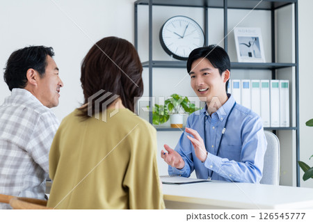 Middle-aged couple consulting with a planner Middle-aged couple consulting with a planner 126545777
