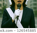 A female candidate (front) giving a street speech during an election campaign 126545885