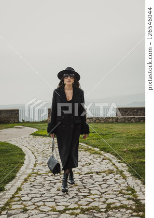 Pretty Woman Walking On The Stone Path Inside The Square Under The Castle 126546044