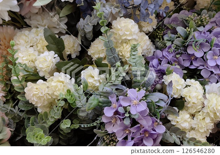 Vibrant floral arrangement featuring a mix of colorful flowers and greenery in a decorative setting Vibrant floral arrangement featuring a mix of colorful flowers and greenery in a decorative setting 126546280