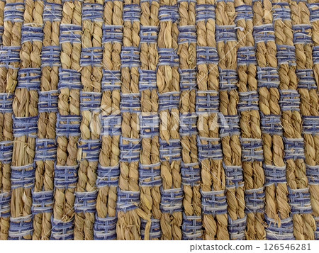 woven carpet displaying intricate patterns natural fibers in muted colors and blue accents. closeup. woven carpet displaying intricate patterns natural fibers in muted colors and blue accents. closeup. 126546281