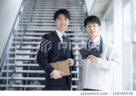 Business: Young man talking while looking at a tablet Business: Young man talking while looking at a tablet 126546548