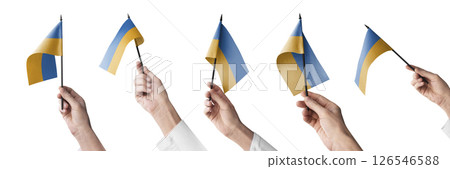 The Ukraine flag in hand in different angles on a white background 126546588