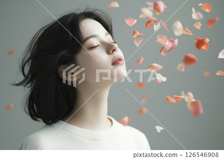 Woman with long black hair is looking at the camera 126546908
