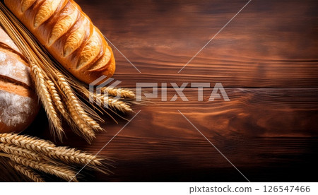 小麥和新鮮出爐的麵包在木紋上閃閃發光，複製空間 3 126547466