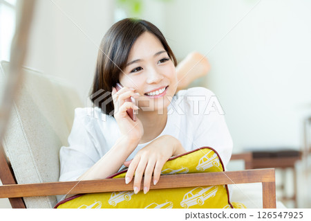 A young lady calling on a smartphone 126547925