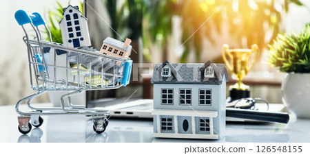 shopping cart and beside it, symbolizing comparison in real estate investments, home buying, and property decisions 126548155