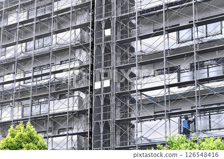 Yokohama cityscape in Japan - View of scaffolding and protective netting set up for repairs and inspections of apartment buildings (Yokohama city) Yokohama cityscape in Japan - View of scaffolding and protective netting set up for repairs and inspections of apartment buildings (Yokohama city) 126548416
