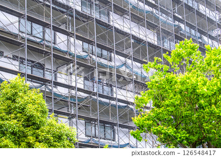 Yokohama cityscape in Japan - View of scaffolding and protective netting set up for repairs and inspections of apartment buildings (Yokohama city) 126548417