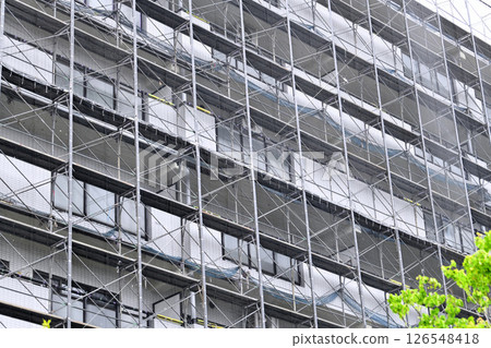 Yokohama cityscape in Japan - View of scaffolding and protective netting set up for repairs and inspections of apartment buildings (Yokohama city) 126548418