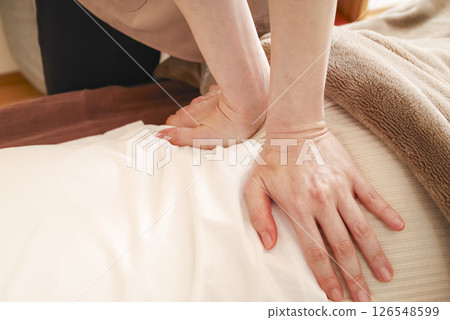 Woman doing back massage Woman doing back massage 126548599