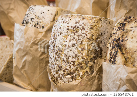 Freshly baked traditional loaves of wheat or rye bread with grains in bakery Freshly baked traditional loaves of wheat or rye bread with grains in bakery 126548761