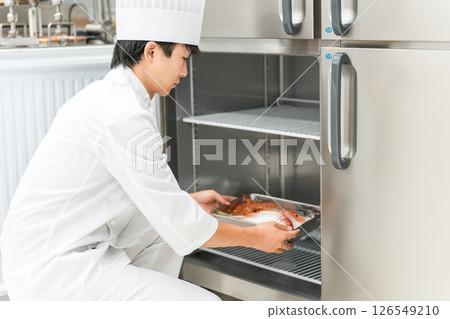一位身穿廚師服的男廚師從冰箱取出食材 126549210
