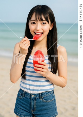 Young woman eating shaved ice at the beach Young woman eating shaved ice at the beach 126550215