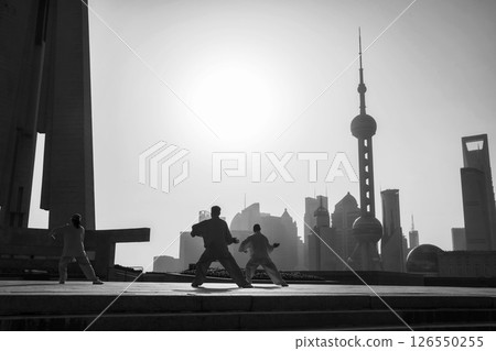 Chinese people exercise Tai Chi at People Heroes Tower at sunrise, Shanghai Chinese people exercise Tai Chi at People Heroes Tower at sunrise, Shanghai 126550255
