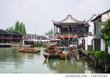 Chinese waterman paddle boat along Zhujiajiao water town Chinese waterman paddle boat along Zhujiajiao water town 126550260