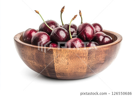 A wooden bowl filled with fresh, dark red cherries, each covered in water droplets, creating a visually appealing and appetizing image. 126550686