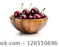 A wooden bowl filled with fresh, dark red cherries, each covered in water droplets, creating a visually appealing and appetizing image. 126550696