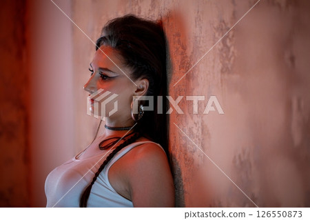 A Stylish Portrait of a Young Woman Captured Against a Beautifully Textured Background 126550873