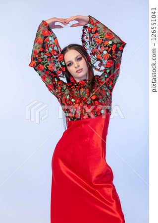 An Elegant Woman Dressed in a Traditional and Beautiful Floral Red Dress, exuding charm and grace An Elegant Woman Dressed in a Traditional and Beautiful Floral Red Dress, exuding charm and grace 126551041