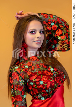 An Elegant Model in a Beautiful Floral Dress, Complemented by Dramatic and Artistic Makeup 126551060