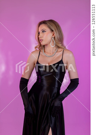 An Elegant Fashion Portrait Featuring a Chic Black Dress Adorned with Glamorous Accessories 126551113