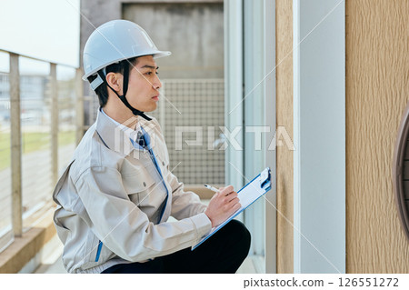 A young male construction worker checking something 126551272
