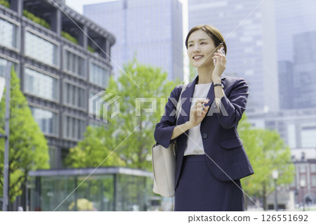 A young businesswoman talking on a smartphone in an office district 126551692