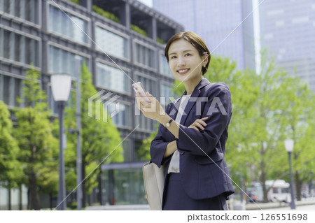 A young businesswoman talking on a smartphone in an office district A young businesswoman talking on a smartphone in an office district 126551698