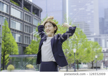 Young businesswoman stretching outdoors Young businesswoman stretching outdoors 126552009