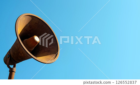 Old Megaphone Against a Bright Blue Sky, Capturing Attention in a Sunny Outdoor Setting 126552837