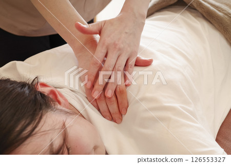 Woman having a shoulder and back massage Woman having a shoulder and back massage 126553327
