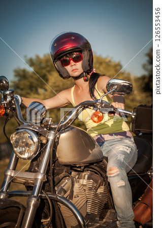 Biker woman sitting by her motorcycle... Biker woman sitting by her motorcycle... 126553456