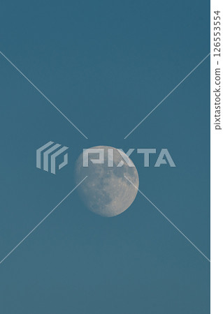 Almost full moon over a blue sky. 126553554