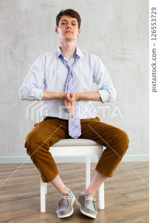 Young guy office worker doing exercises on chair Young guy office worker doing exercises on chair 126553729