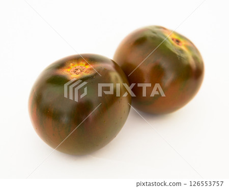 Ripe black tomatoes on a white background 126553757