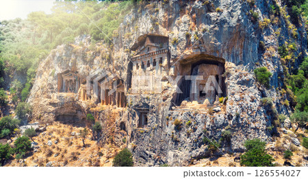 The ancient ruins of Myrna city close to Antalya Turkey, with creepy rock tombs lightened by sun going down. The ancient ruins of Myrna city close to Antalya Turkey, with creepy rock tombs lightened by sun going down. 126554027