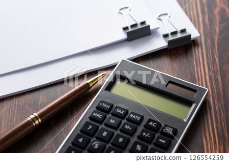 Documents and calculator clipped together Documents and calculator clipped together 126554259