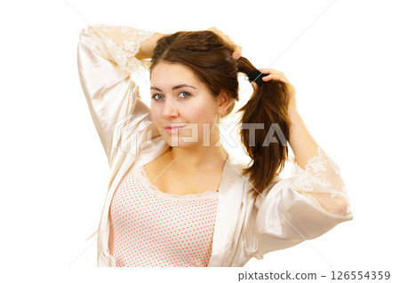 Girl with no makeup unties her hair 126554359