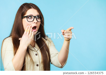 Shocked and surprised woman pointing Shocked and surprised woman pointing 126554375