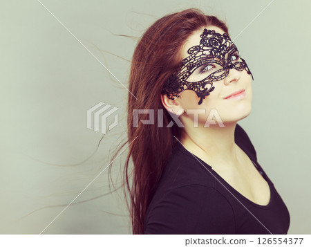 Mysterious woman wearing lace mask 126554377