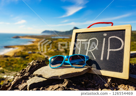 Black board with word trip against sea coast 126554469