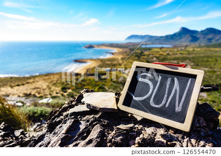 Black board with word sun against sea coast 126554470