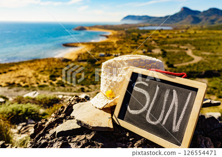 Black board with word sun against sea coast 126554471