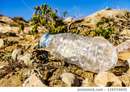 Plastic empty water bottle abandoned on nature 126554608