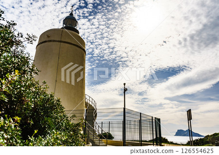 Lighthouse and Gibraltar rock, La Alcaidesa, Spain. Lighthouse and Gibraltar rock, La Alcaidesa, Spain. 126554625