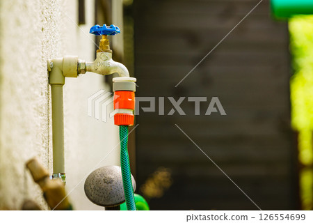 Garden tap with hosepipe attached. 126554699