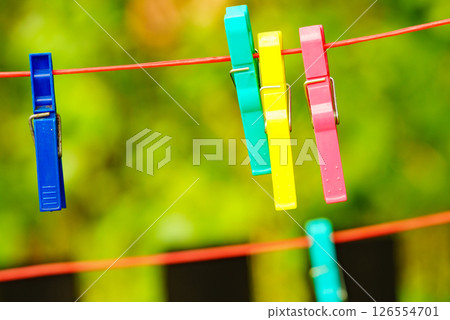 Clothes pegs on line outdoor. Housework 126554701