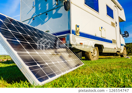 Camper with portable solar panel on coast 126554747